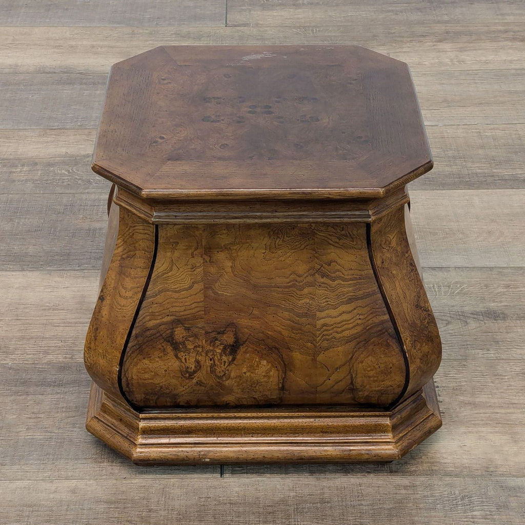 a small oak table with a small square top.