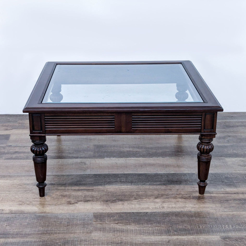 a large antique chinese mahogany coffee table with glass top.