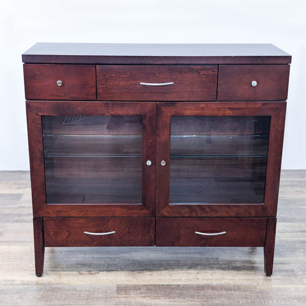 Dark wood sideboard with glass front doors and five drawers.