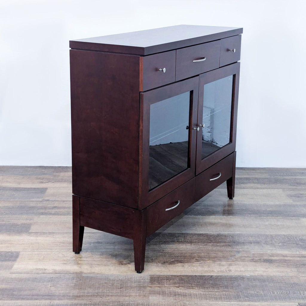 Side view of a wooden sideboard with glass doors and drawer storage.