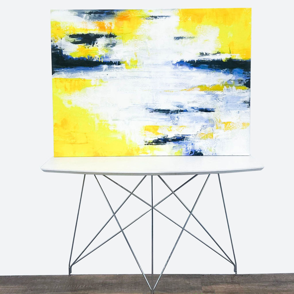 a yellow and blue abstract painting on a white table.