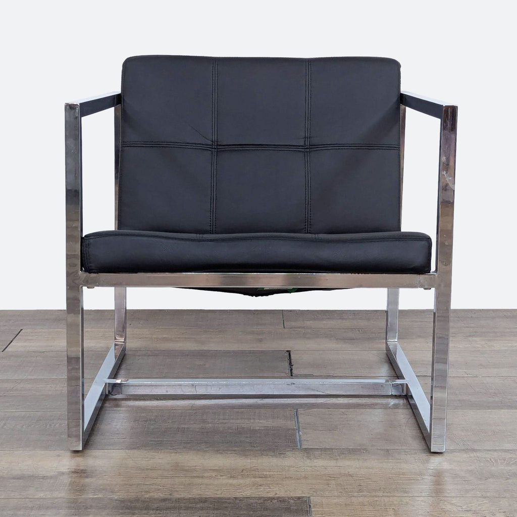 a pair of chrome and black leather lounge chairs