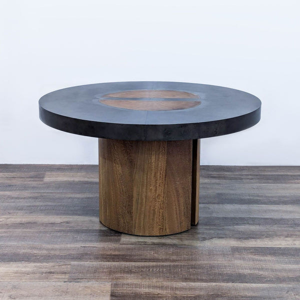 a round table with a black marble top.