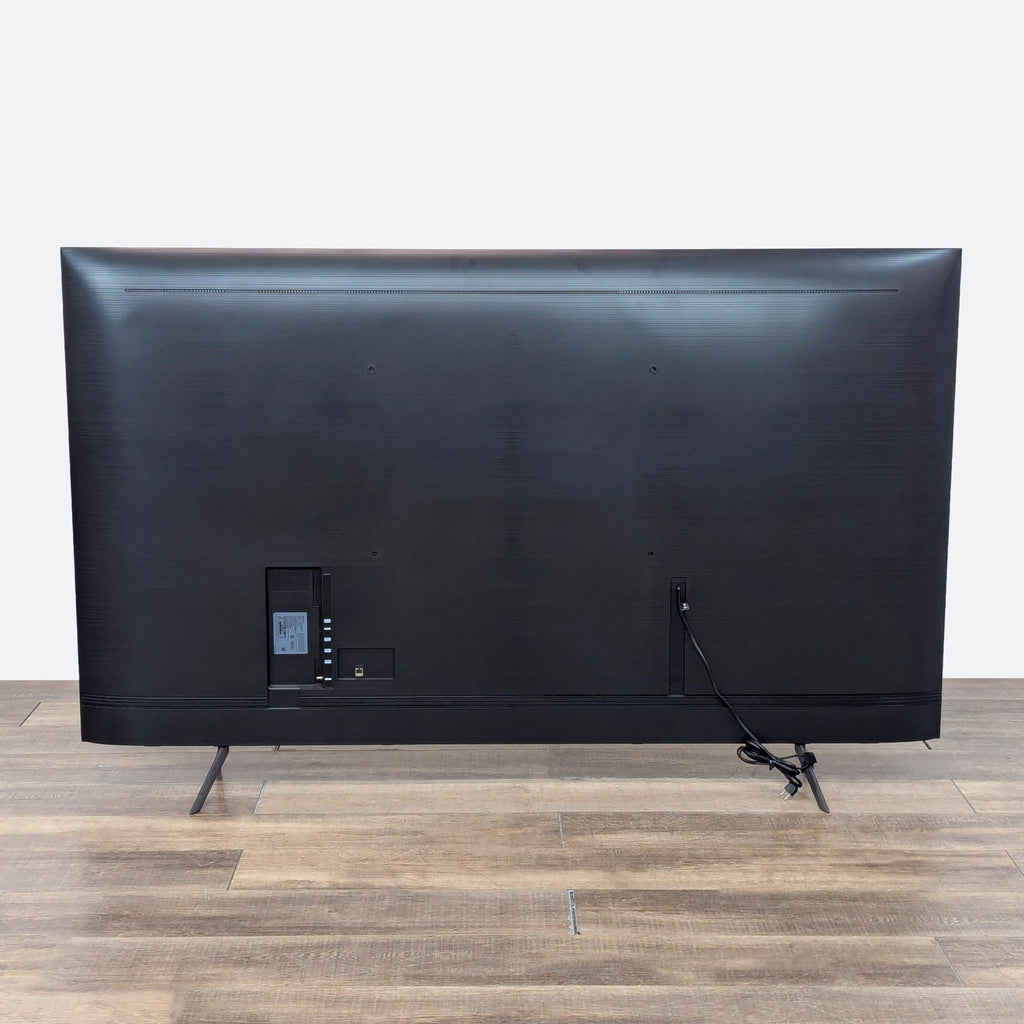 the back of the tv is a black leather case with a built in display.