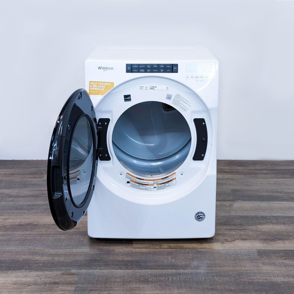 a washing machine with a door open on a wooden table.