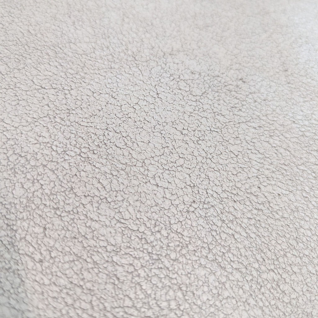 a close up of a white leather surface with a textured surface.