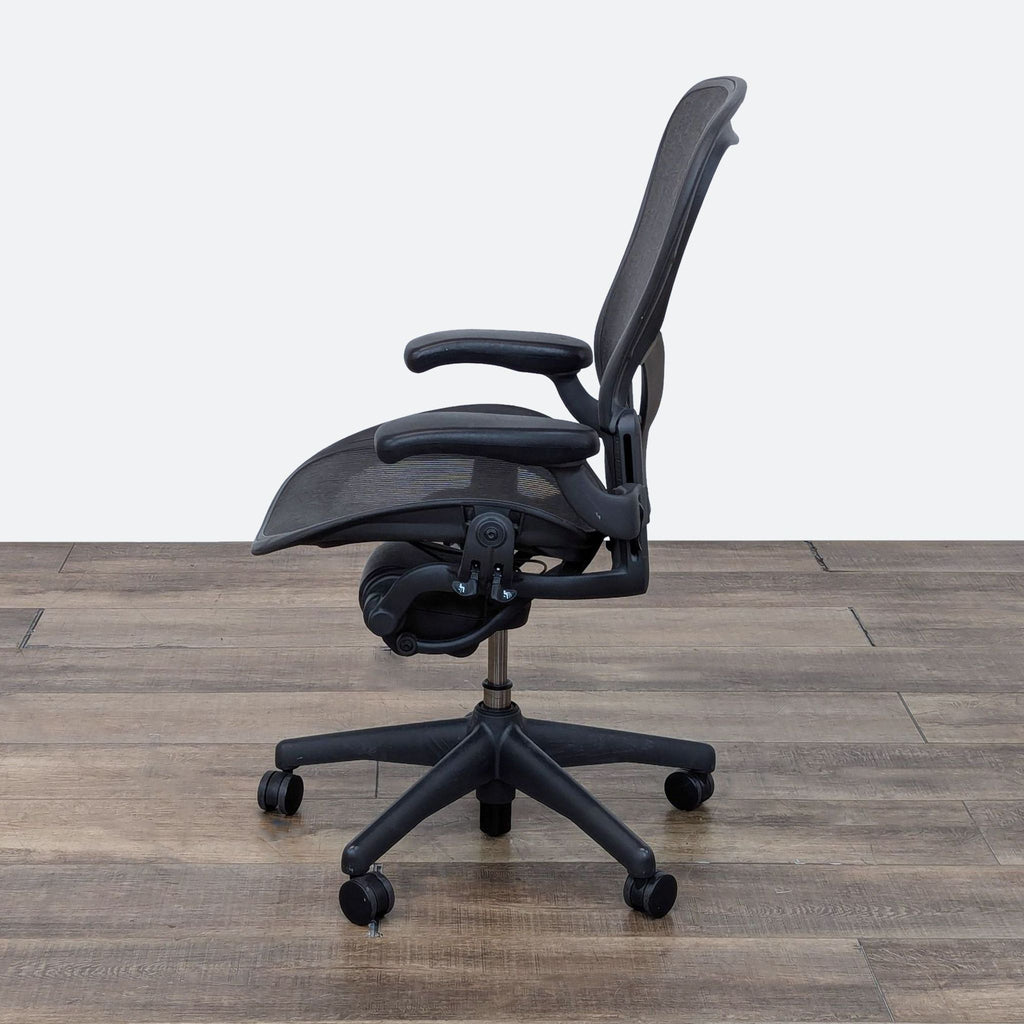 a black office chair with a black seat and arms.