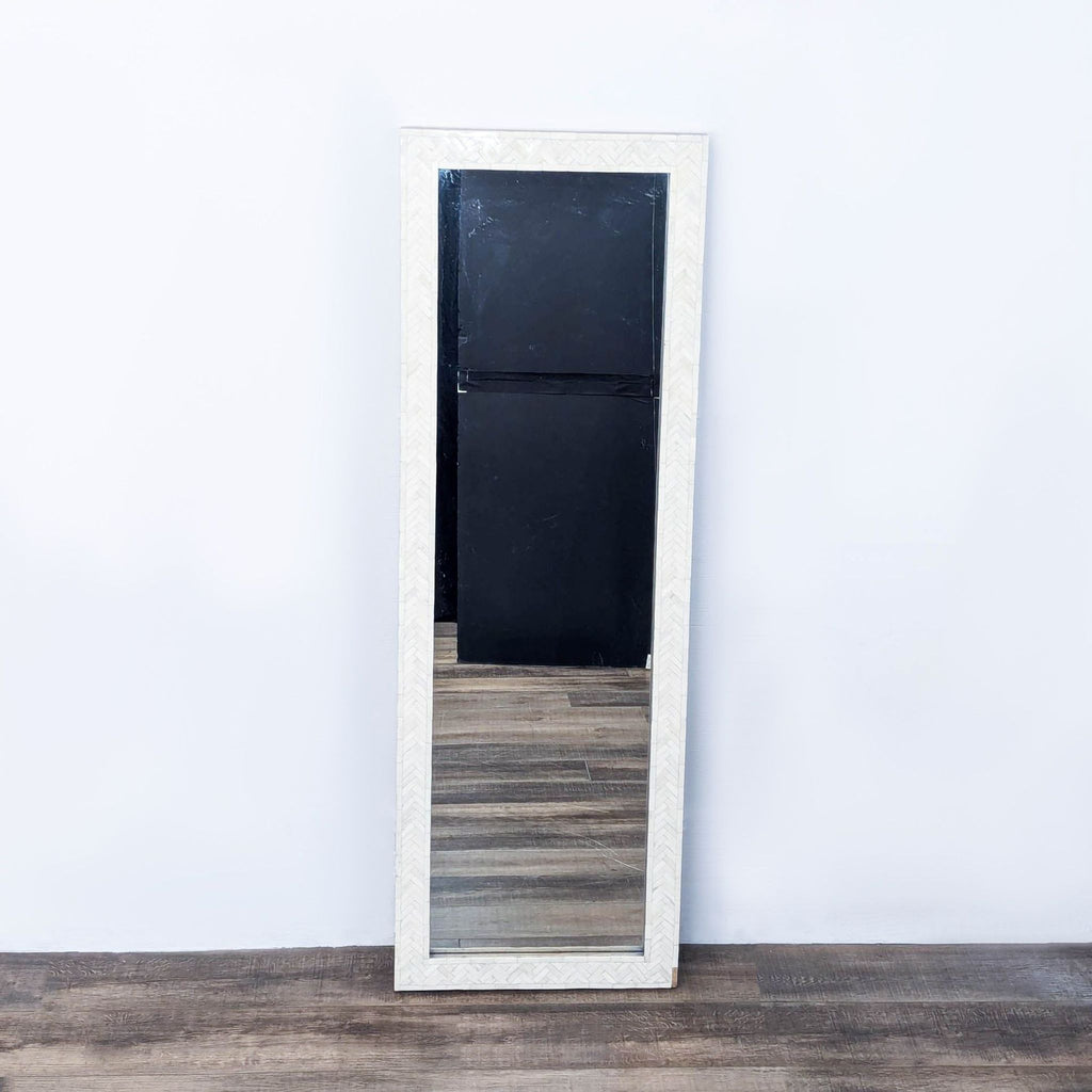 a large white mirror with a black door.