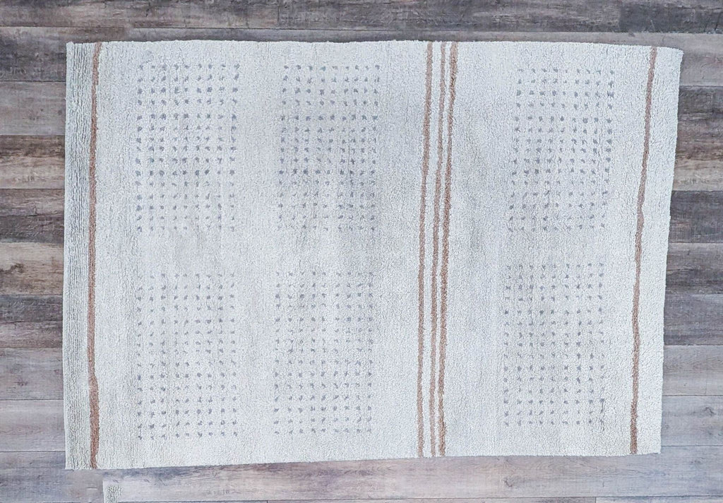 a close up of a white and brown table runner with a brown stripe on it.