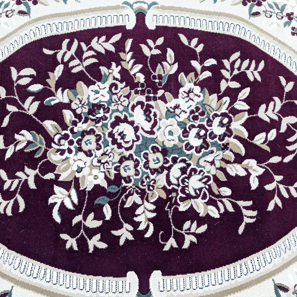 a close up of a purple and white rug