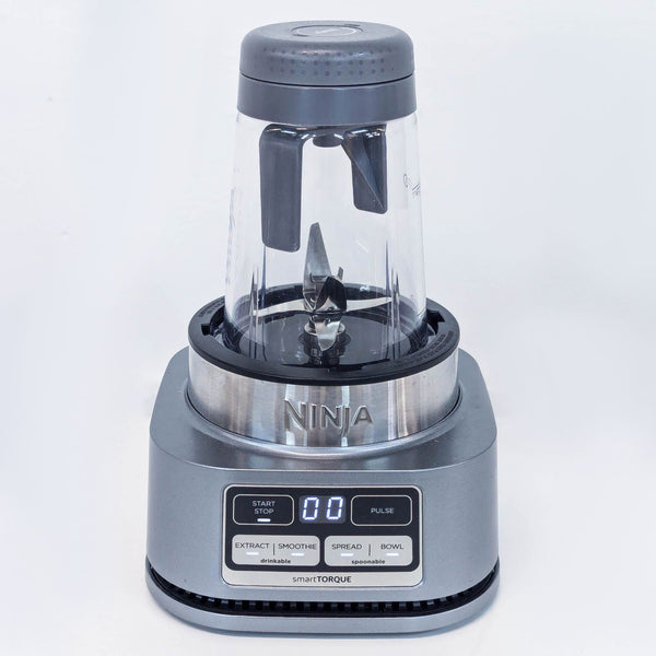 a stainless steel blender with a blender on a white background.