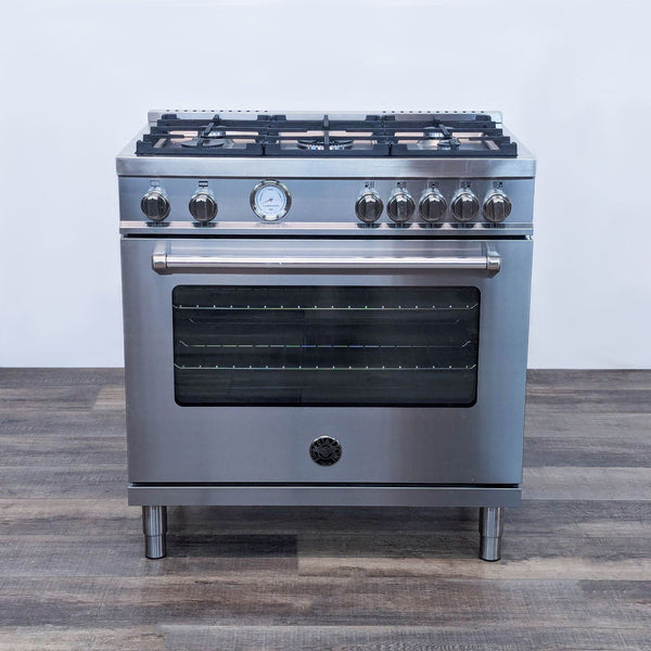 a stainless steel stove with four burners on the front.