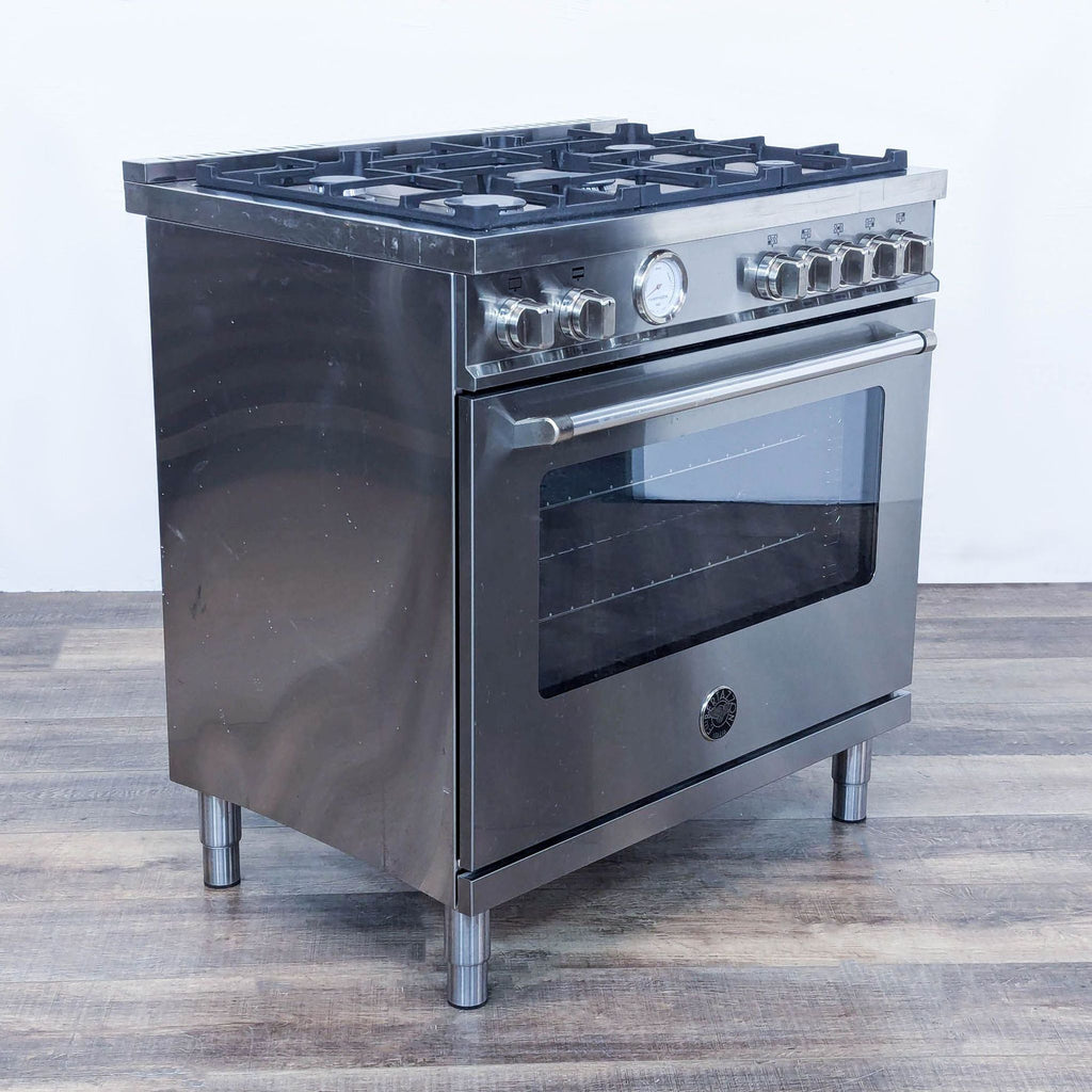 a stainless steel stove with four burners.