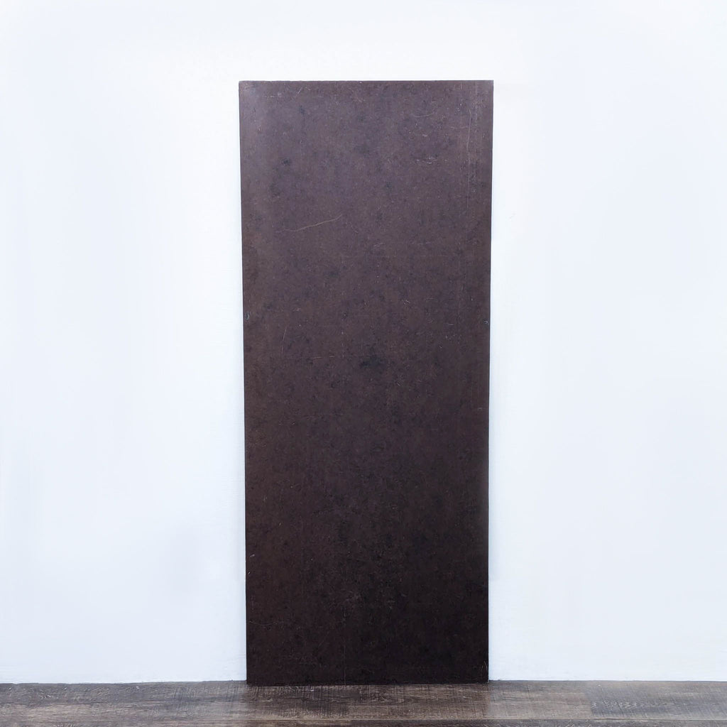 a large, rectangular, dark brown, and white wall with a large rectangular door.