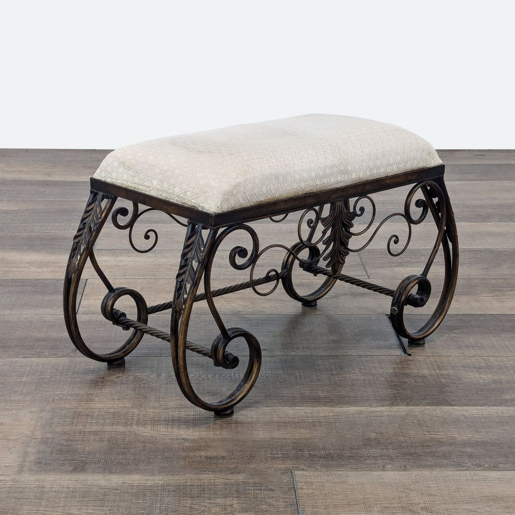 a wrought iron bench with a curved seat and footrest.