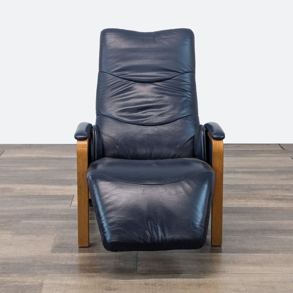 a modern recliner with a blue leather upholstery.