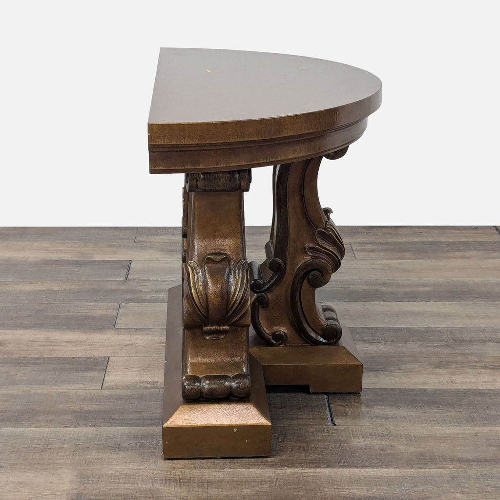 2. Side view of the Reperch console table with carved, decorative wooden base and a half-moon tabletop.