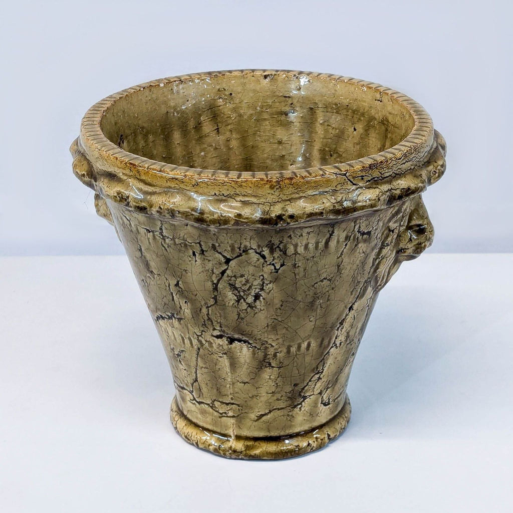 a large vintage french brass planter with a carved head and a carved head.