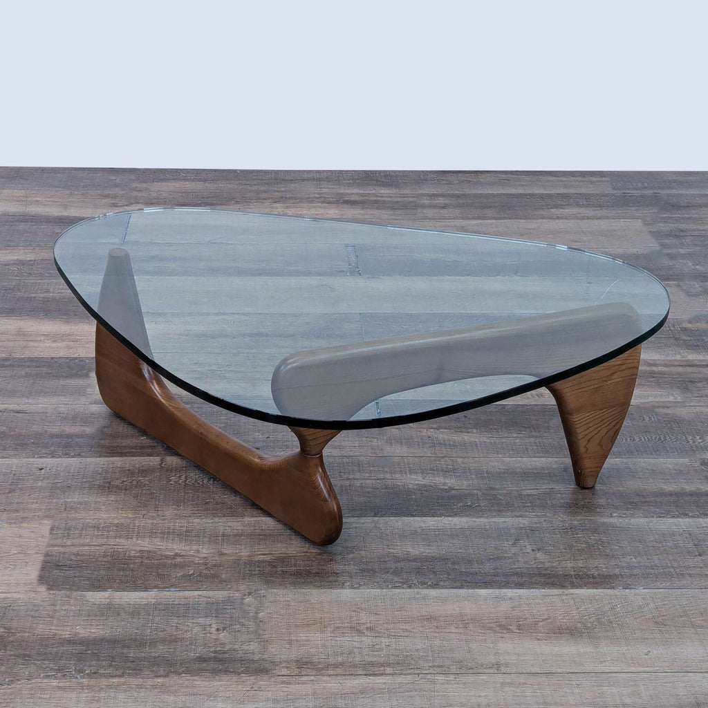 a coffee table with a glass top and a wooden seat.