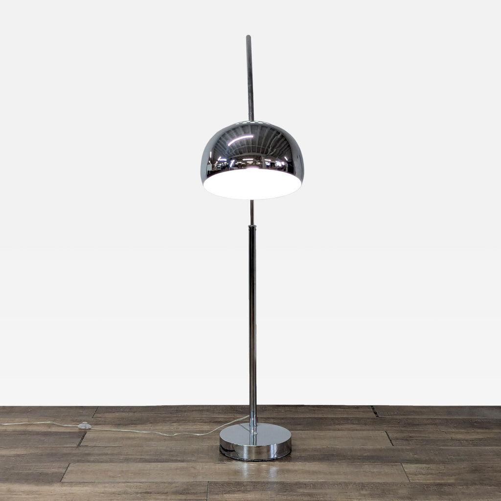 a chrome floor lamp with a chrome base and a chrome base.