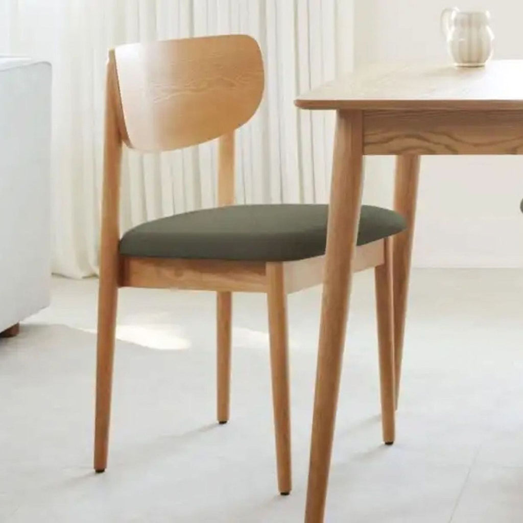 the [ unused0 ] dining chair is a solid oak with a green cushion.