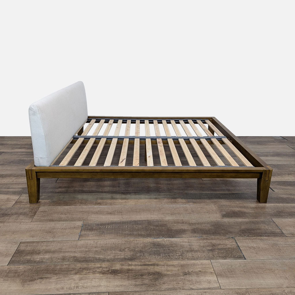 the bed frame with white cushions