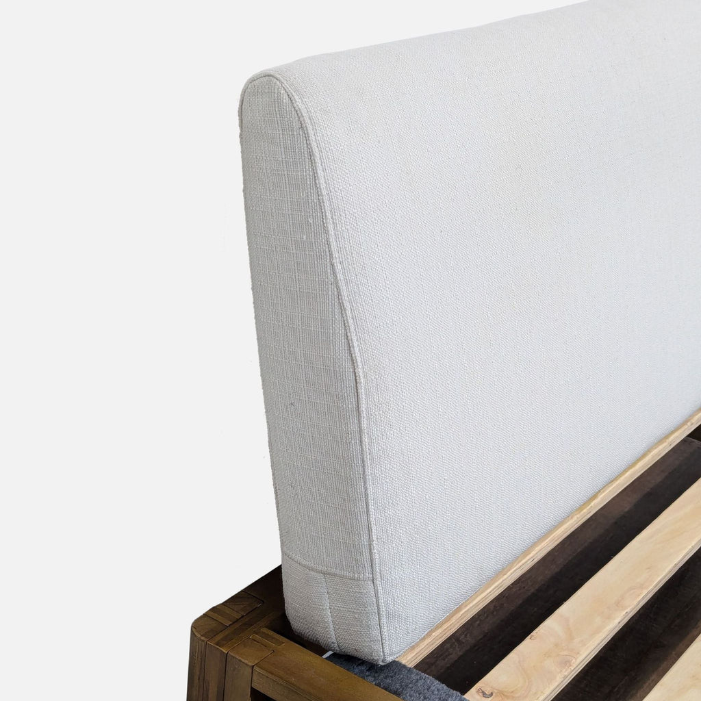 the back of a white sofa with a white cushion.