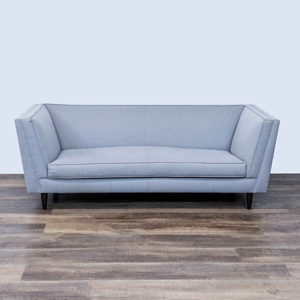 sofa is a modern sofa design with a modern design. the sofa is made of a soft grey