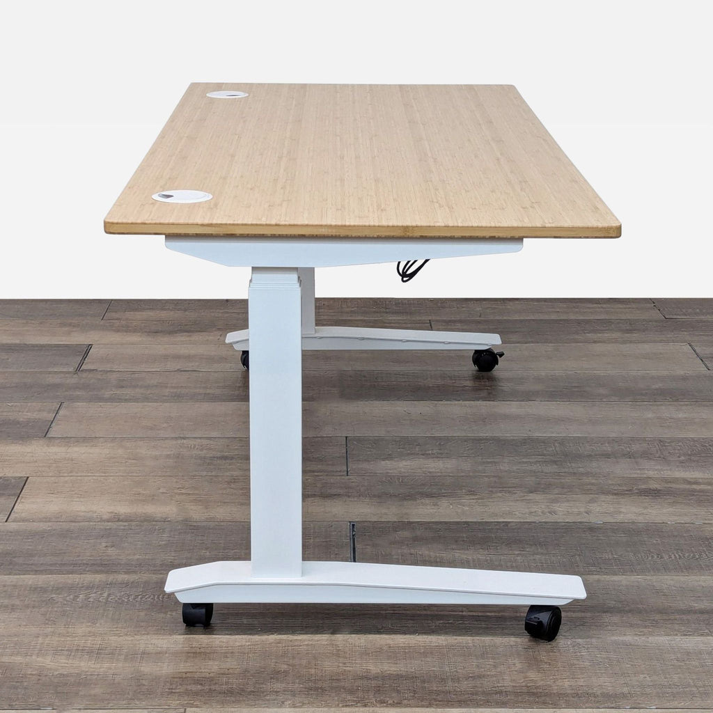 a white table with a white top and a black wheels.