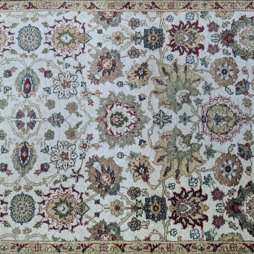 a large oriental rug with a floral pattern.