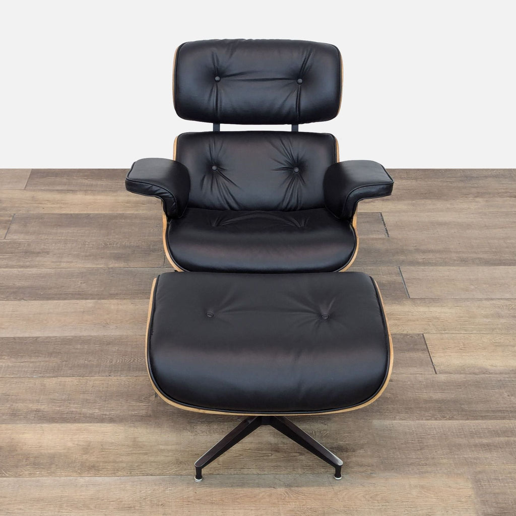 a pair of [ unused0 ] lounge chairs in black leather with a gold trim.