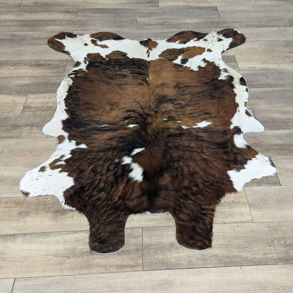a brown and white cow hide rug
