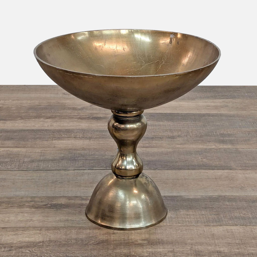 a large brass bowl with a round base.