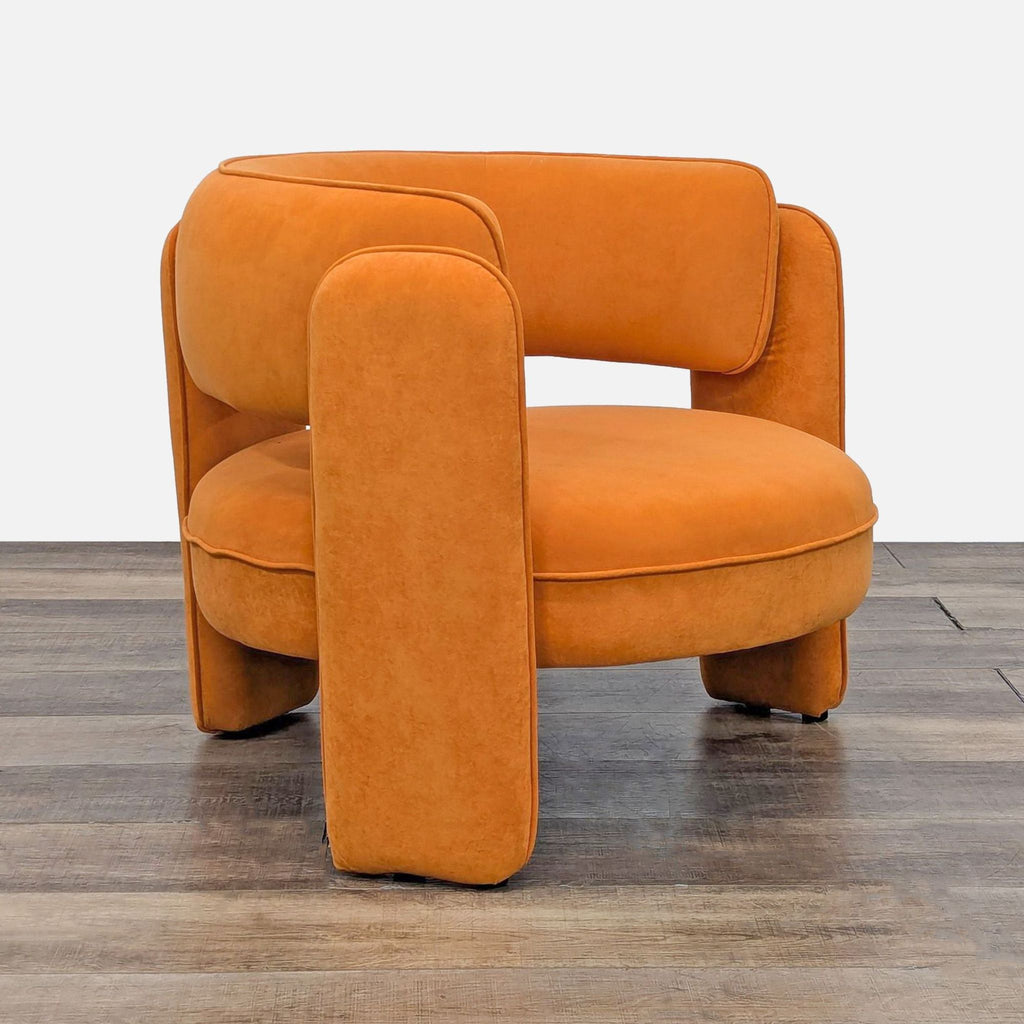 a pair of orange velvet armchairs