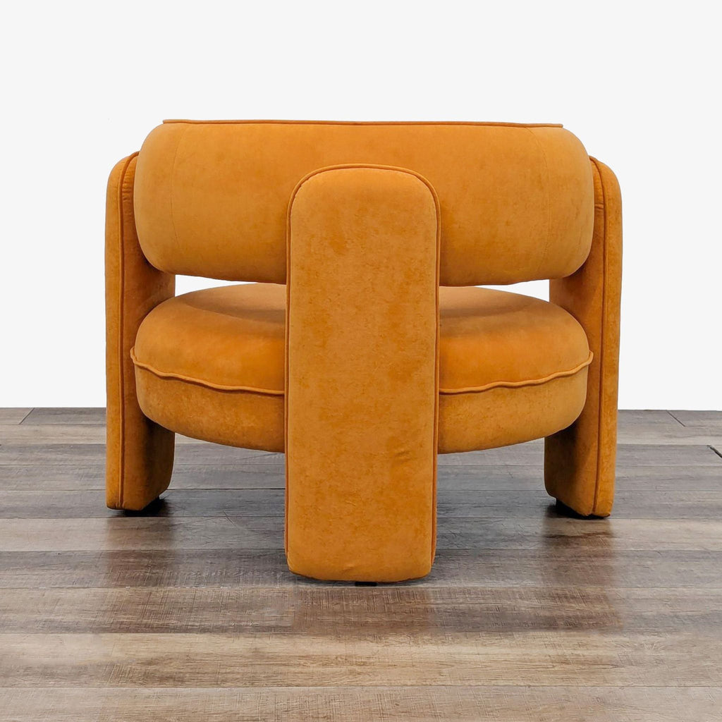 a pair of orange leather armchairs