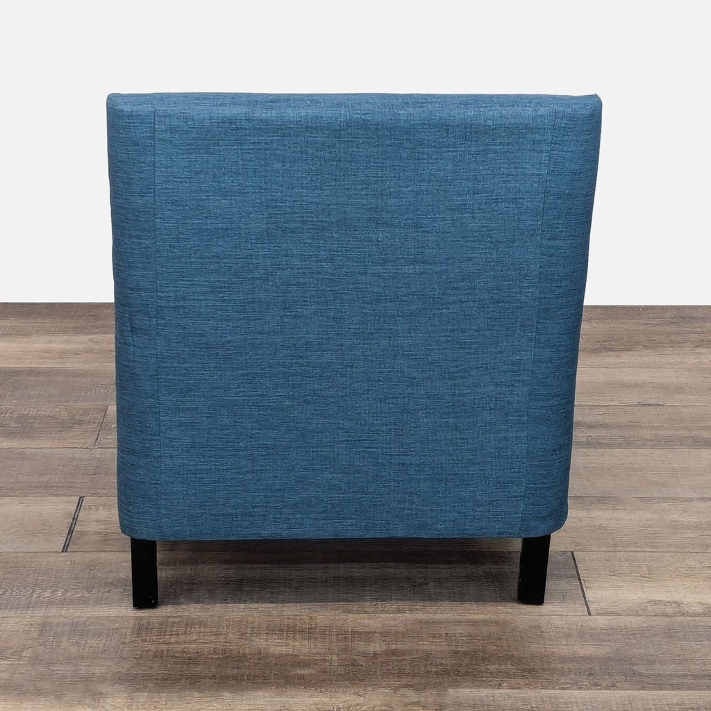 a blue fabric chair with a black base and a black base.