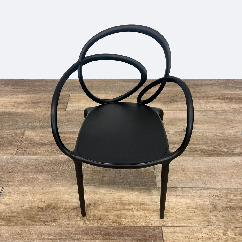 a black chair with a curved back and a curved back.