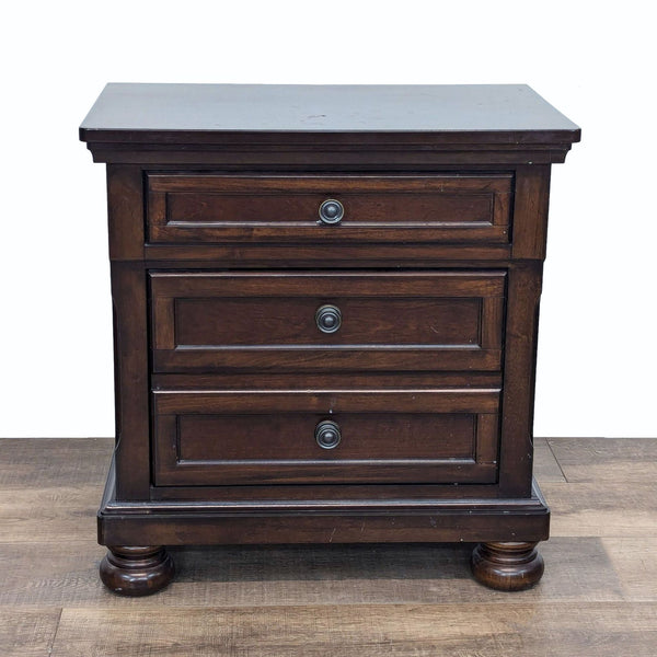 a dark wood chest of drawers with a dark wood finish.