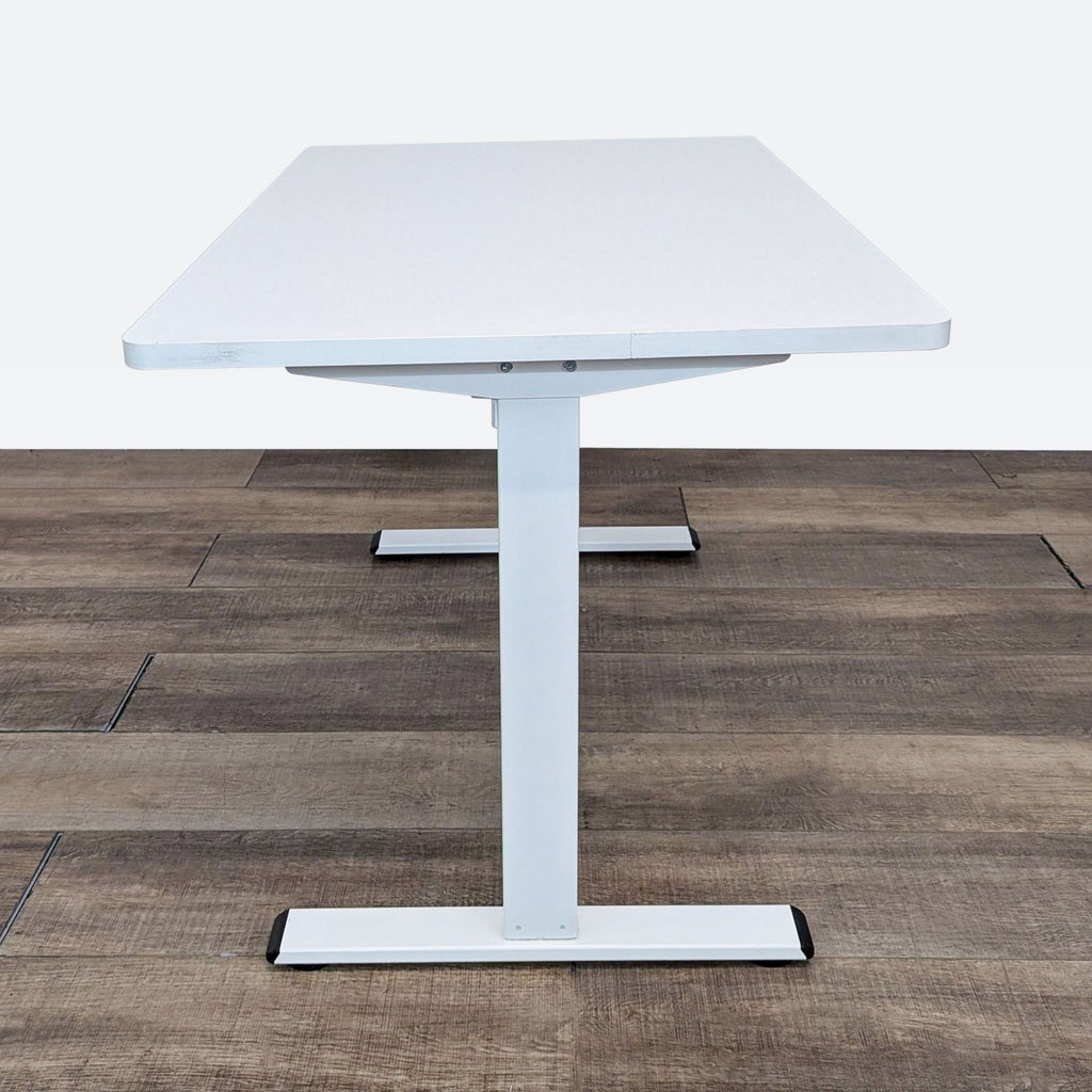 a white square table with a white top.