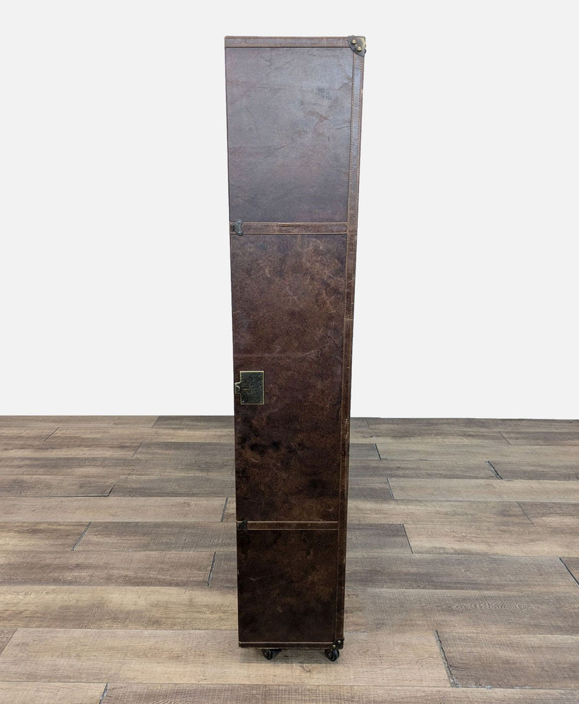 a large industrial style metal and wood column with a brass plated base.