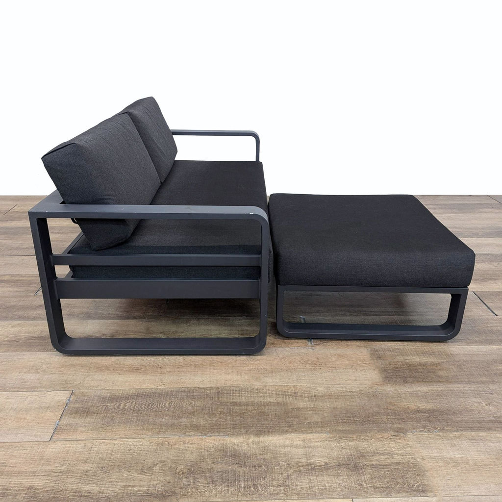 a pair of black and grey lounge chairs