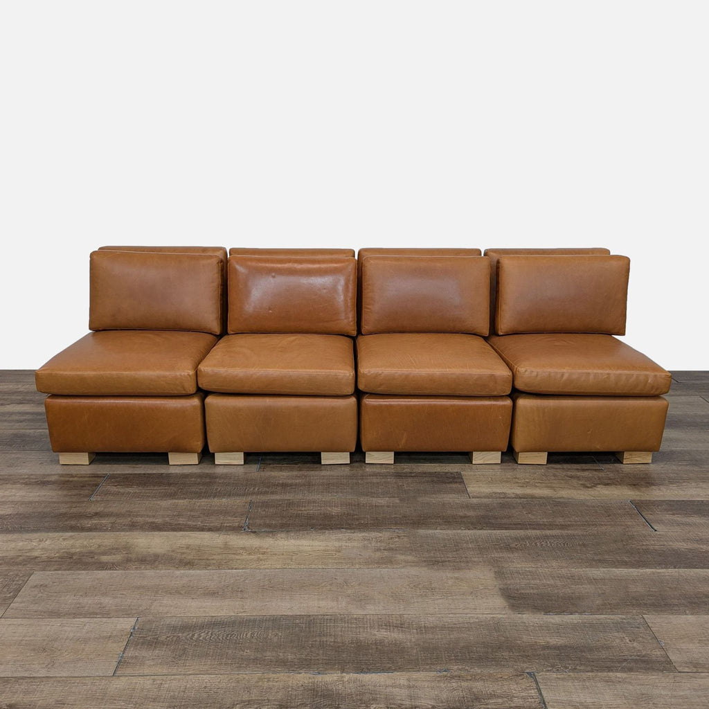 a brown leather sofa with a square base