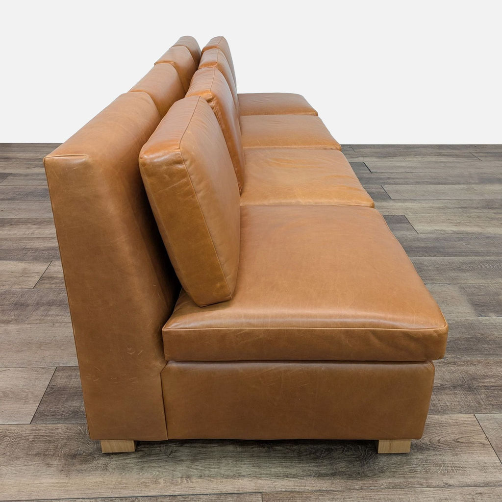 a pair of leather sofas in the style of [ unused0 ]