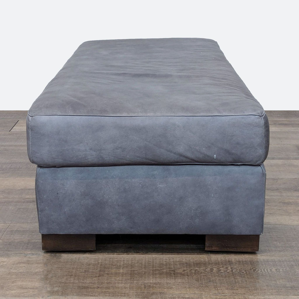 a pair of blue velvet ottomans