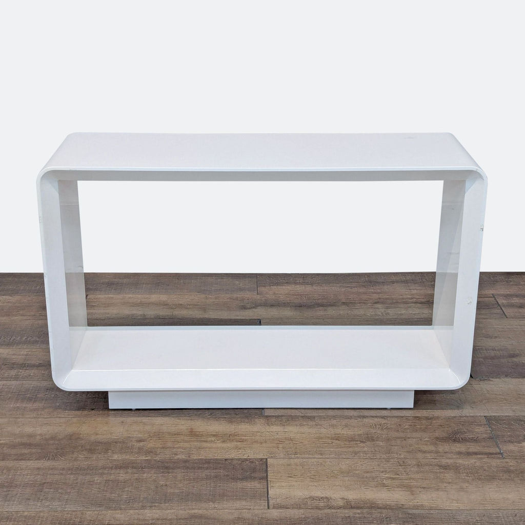 the side table is made of a white lacquered wood with a glass top.