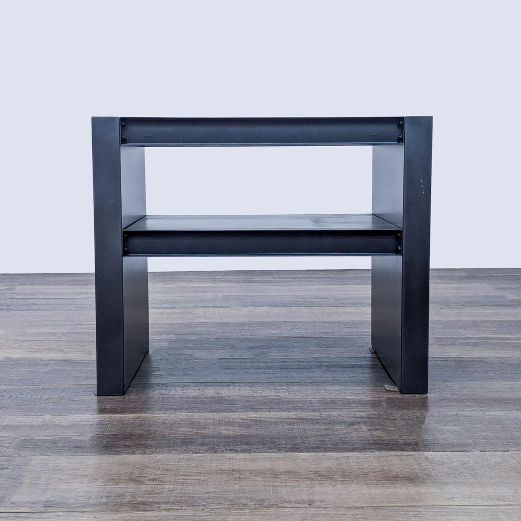 a pair of black steel and glass side tables