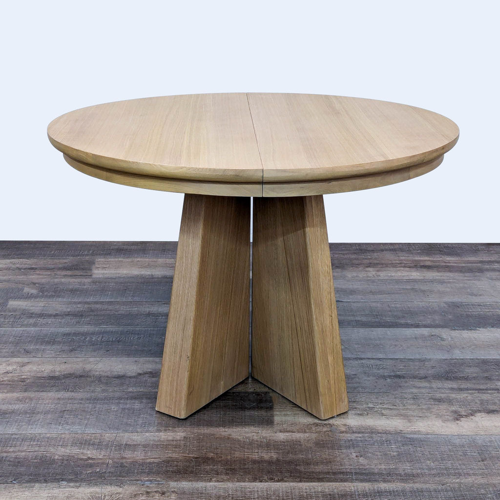 the table is made of solid wood and has a round top.