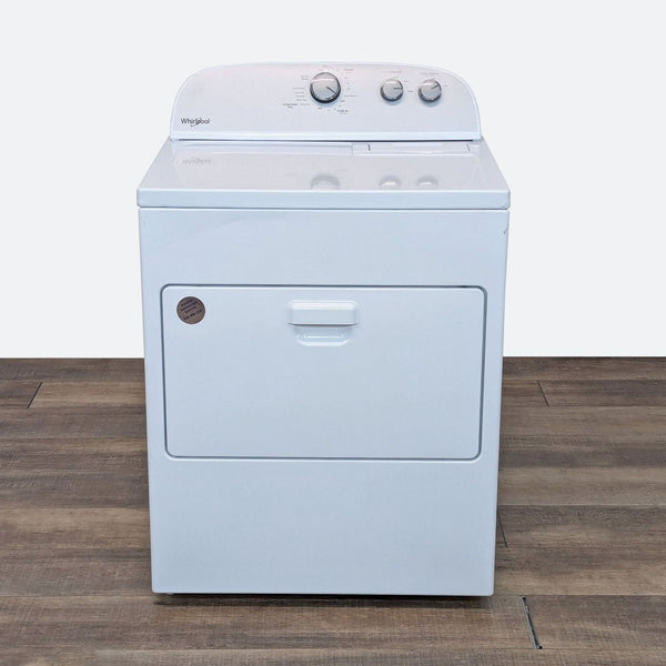 a white washing machine on a wooden floor.