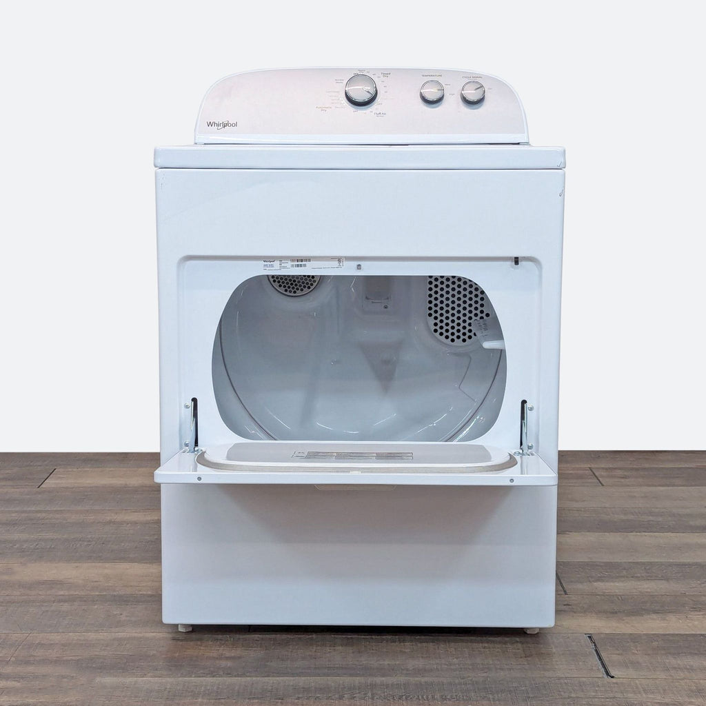 a washing machine on a wooden floor.