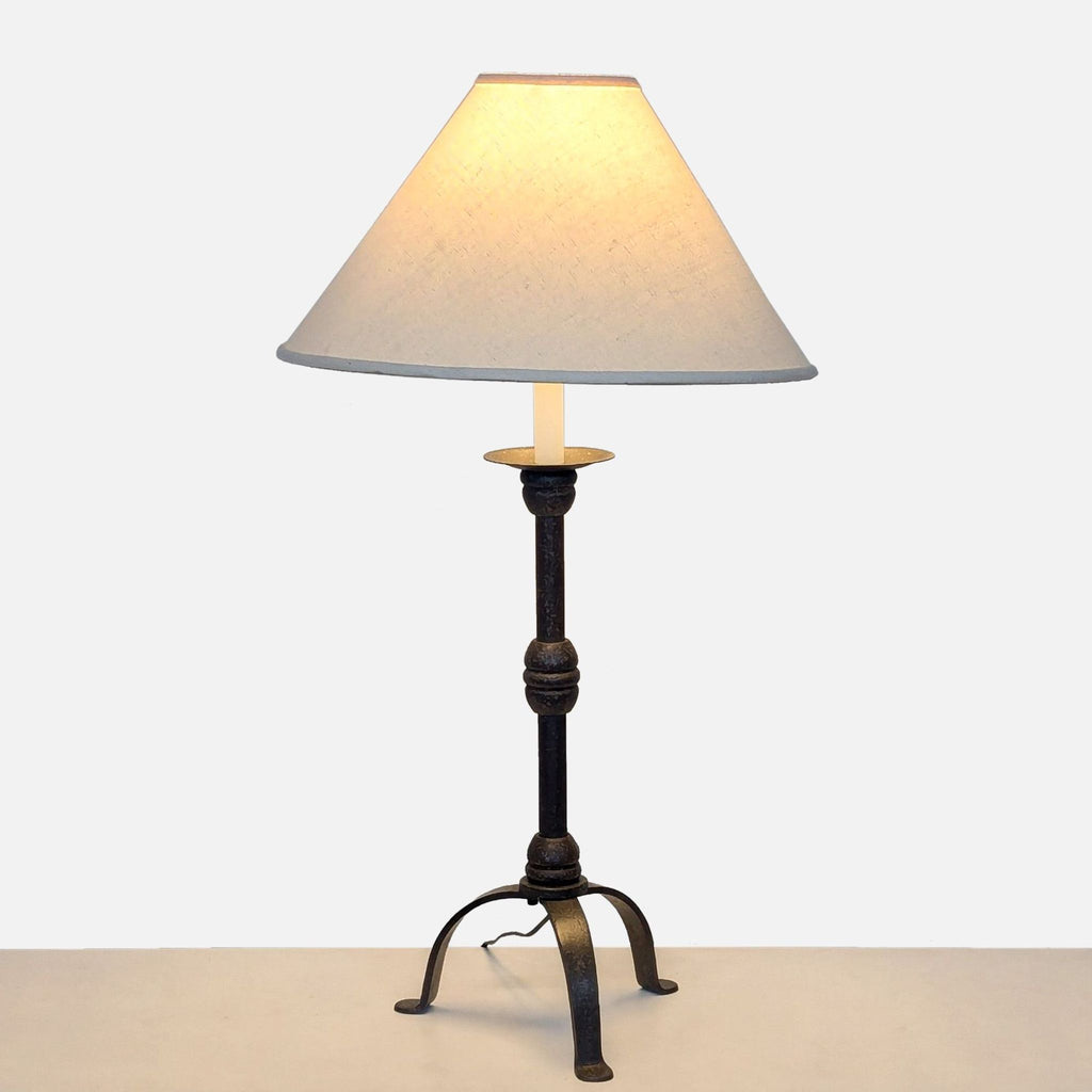 a vintage table lamp with a cast iron base and a white shade.